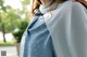 A woman wearing a blue and white polka dot scarf.