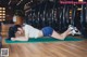 A woman laying on a yoga mat in a gym.