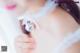 A woman in a white dress holding a silver ball.