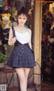 A woman in a school uniform posing in front of a store.